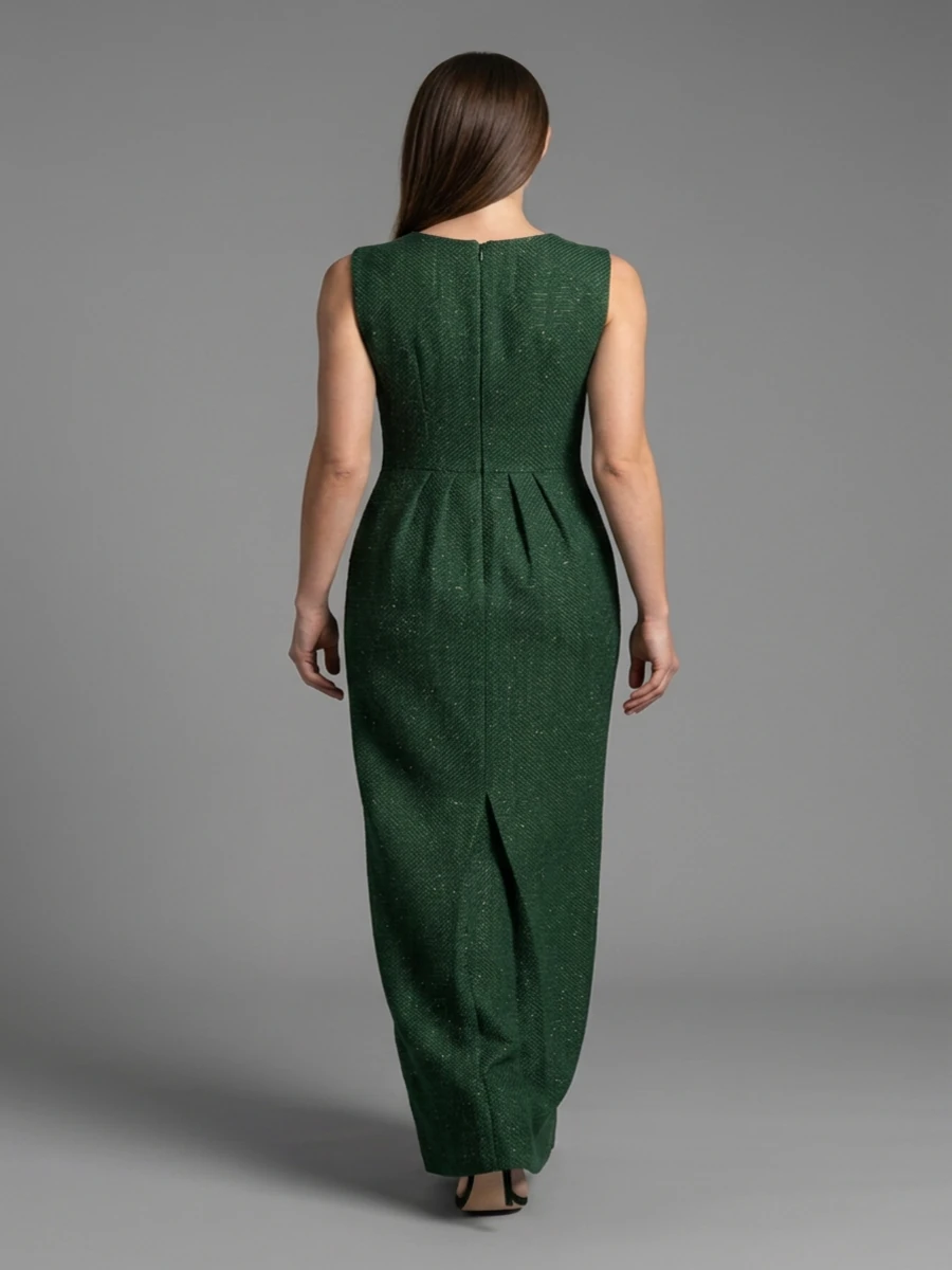 The same model and dress from behind, with the back zip, waist pleats, and a short slit at the hem.