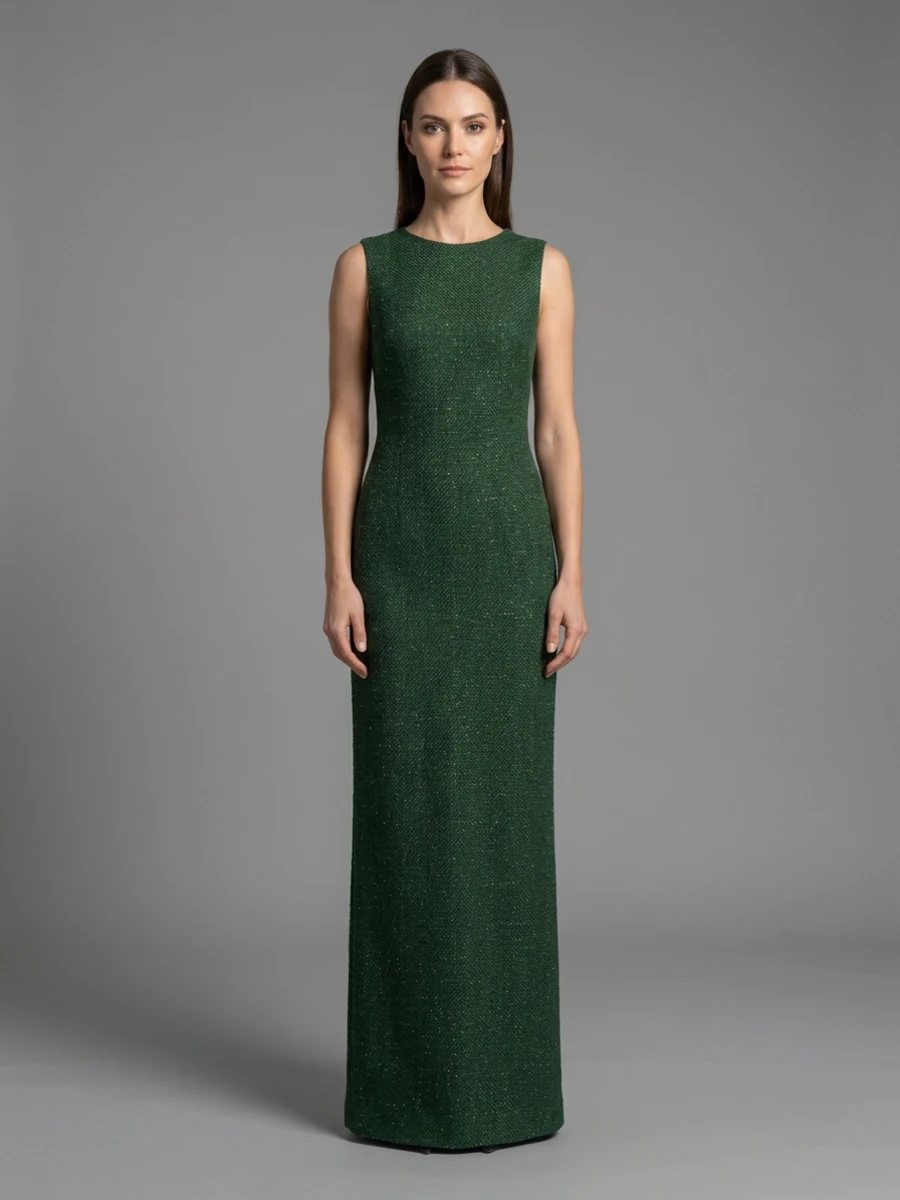 A model faces the camera in a floor-length sleeveless dress in the green and gold fabric, on grey seamless.